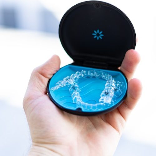 Men,Holding,Invisalign,Braces,In,Hand