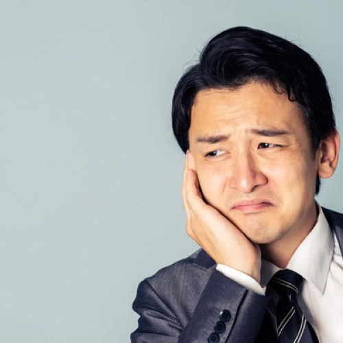 Asian man getting a toothache. oral trouble concept.